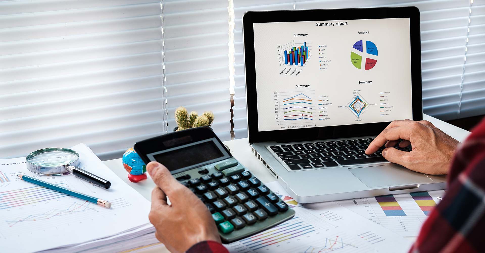 Businessman analyzing investment charts with laptop and calculator on office desk table.Close up.Financial Report Revenue Statistical Accounting Concept.